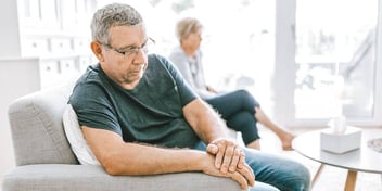 man and woman sitting apart refusing to discuss their divorce