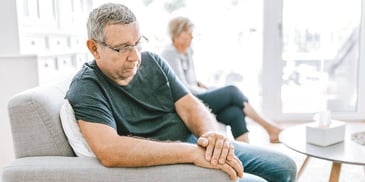 man and woman sitting apart refusing to discuss their divorce