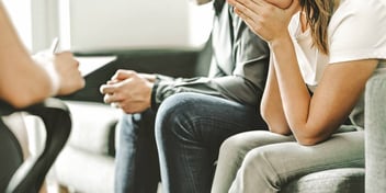 couple sitting in a session with an advisor or mediator