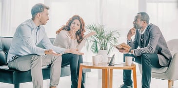 couple negotiating their divorce terms with the help of a mediator lawyer
