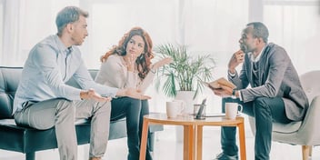 couple negotiating their divorce terms with the help of a mediator lawyer