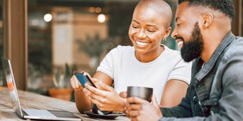 couple looking at something on her phone and smiling