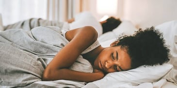 woman laying in bed thinking about the dream she just had