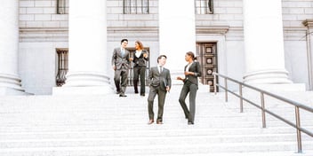 lawyers and clients talking and walking outside courthouse