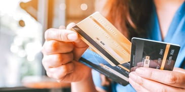 person holding a few credit and debit cards
