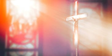 church cross in sunlight window