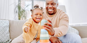 Dad and baby play with toys