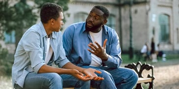 dad and son talking on bench