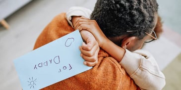Dad hugs his kid who wrote him a note