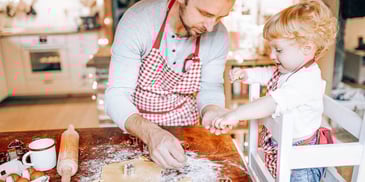 father and child baking something for meal prep