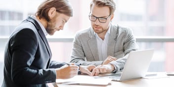 Divorce lawyer meets with client to review documents