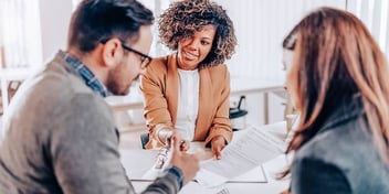 couple meeting with a financial advisor to save money on lawyer fees