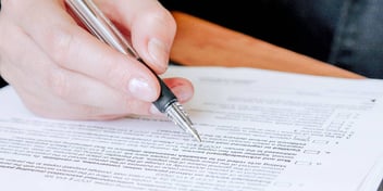 person filling out divorce paperwork