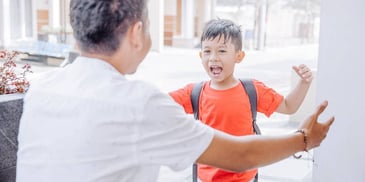 son running into the arms of his father