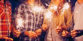 happy blended family celebrating together with sparklers