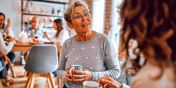 female friends talking and having coffee at a cafe