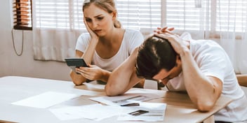 upset couple stressing over their finances
