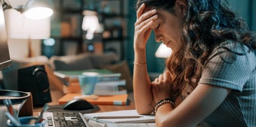 frustrated woman sitting at a desk and worrying about how to divorce her narcissistic spouse