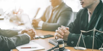 group of men meeting in a legal setting