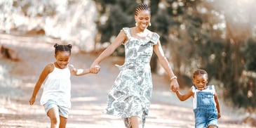 happy mother walking hand in hand with her two children