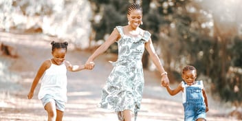 happy mother walking hand in hand with her two children