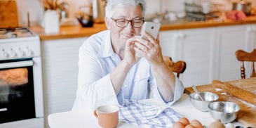 smiling woman reading inspiring quotes on her phone