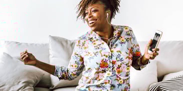 happy woman listening to music at home alone