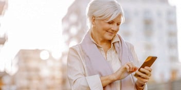 woman looking at her phone planning a vacation