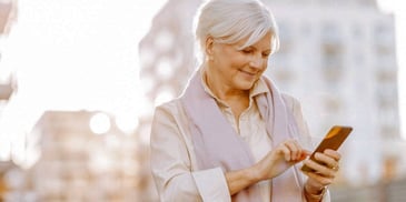 woman looking at her phone planning a vacation