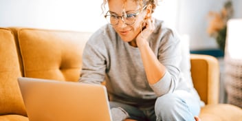 woman working on her laptop and smiling