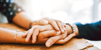 parent holding a teenage child's hand