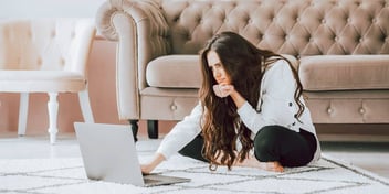 women sitting on the floor using laptop