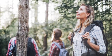 introspective and independent woman out for a hike away from her friend group