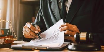 judge reviewing divorce paperwork before signing
