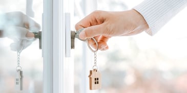 person opening the door to their new home
