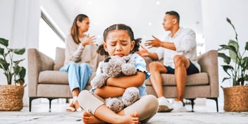 co-parents arguing while their daughter cries and hugs a stuffed animal