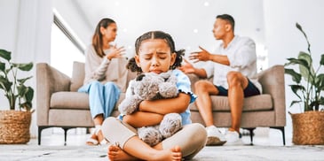 co-parents arguing while their daughter cries and hugs a stuffed animal