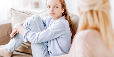 upset daughter listening to her mom talk badly about her father