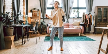 person dancing along to music on their headphones