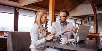 Man and woman use spreadsheet to talk about how to divide property