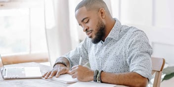 man filling out divorce paperwork