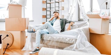 man sitting in a packed up house