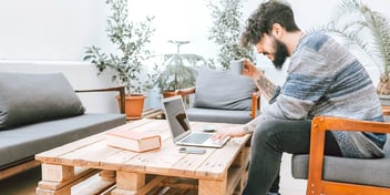 man looking at divorce information on his laptop