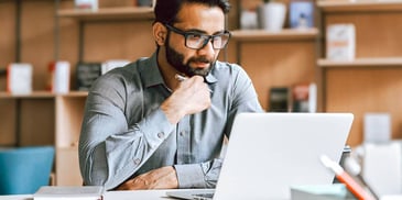 man working on a laptop in deep thought