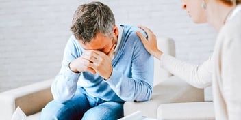 woman comforting a crying man