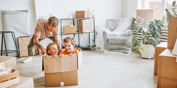 dad and his kids in his new home unpacking boxes