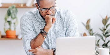 man looking at computer stressed because he missed a deadline