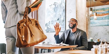 man greets lawyer at a cafe for a relaxed meeting