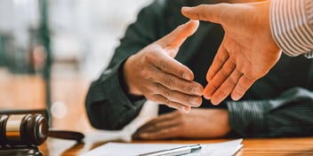 man shakes the hand of a judge who granted his uncontested divorce