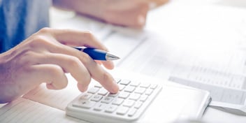 Person uses calculator to figure out their alimony payments